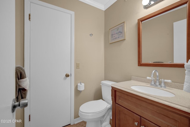 bathroom with vanity, ornamental molding, and toilet