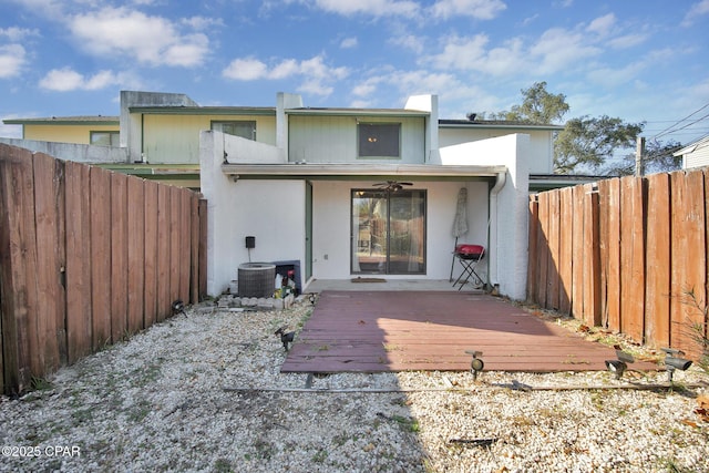 back of property with a wooden deck, central AC unit, and ceiling fan