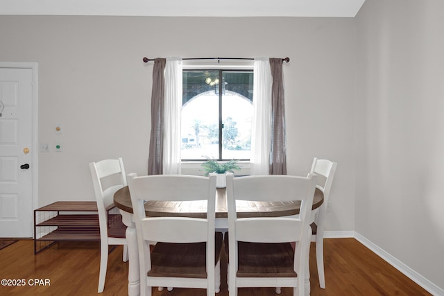 dining space with wood-type flooring