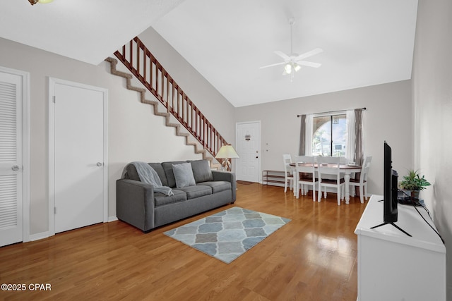 living room featuring wood-type flooring and ceiling fan