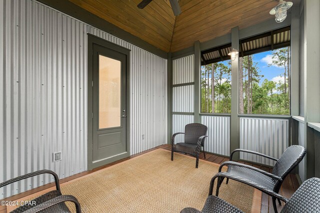 sunroom / solarium with vaulted ceiling, ceiling fan, and wooden ceiling