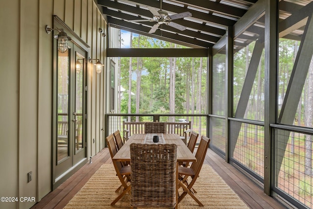 sunroom / solarium with ceiling fan and lofted ceiling