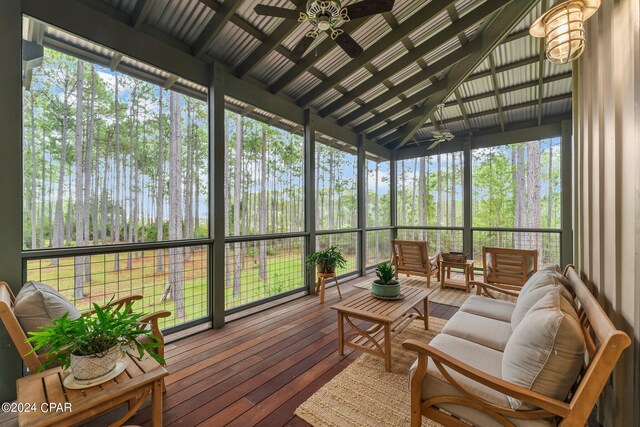 sunroom / solarium with ceiling fan and lofted ceiling