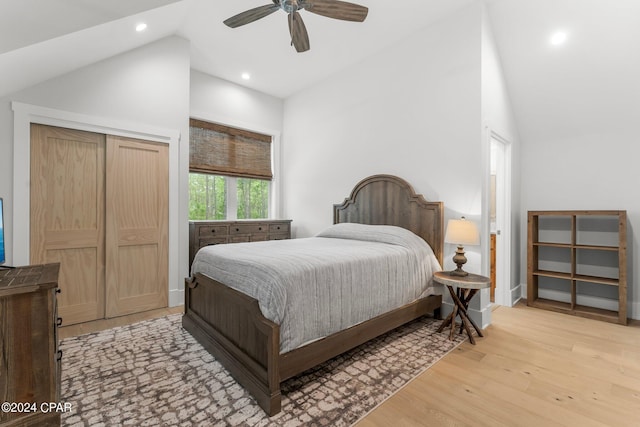 bedroom with light wood-type flooring, a closet, high vaulted ceiling, and ceiling fan