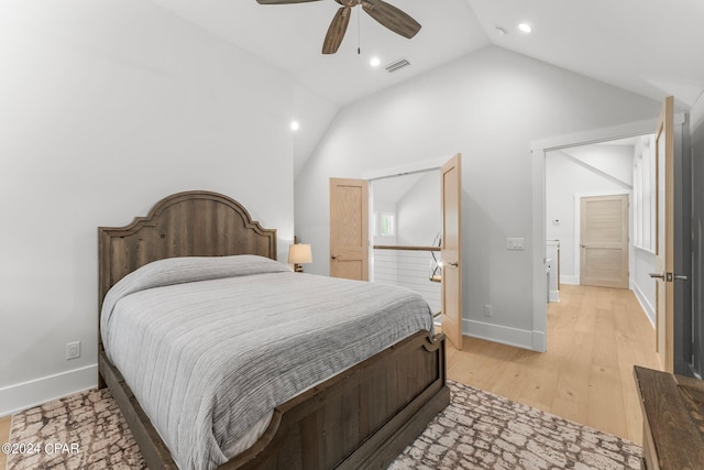 bedroom featuring light wood-style floors, ceiling fan, visible vents, baseboards, and lofted ceiling