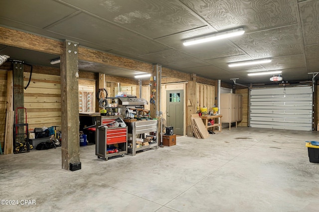 garage with a workshop area and a garage door opener