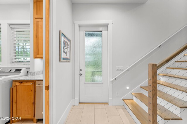 interior space with washer / clothes dryer and light tile patterned floors