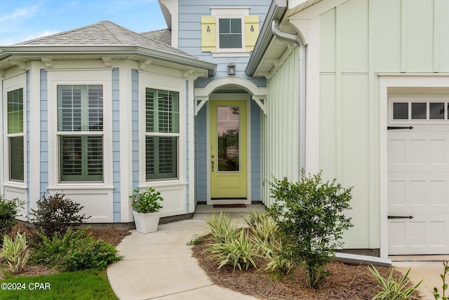 doorway to property with a garage