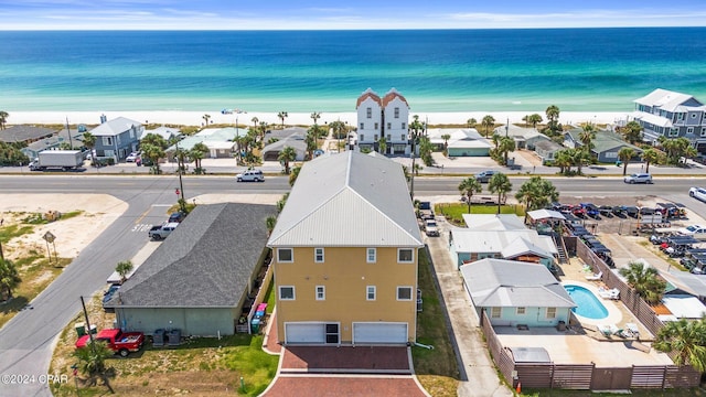 aerial view with a water view and a beach view