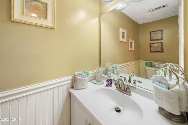 bathroom featuring a textured ceiling and vanity