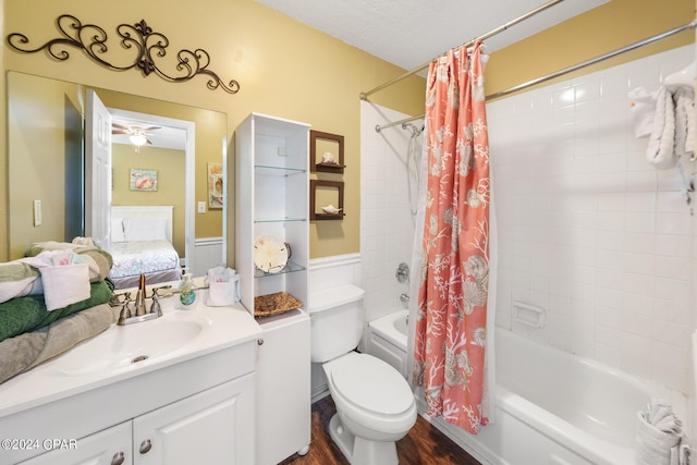 full bathroom featuring a textured ceiling, vanity, shower / bath combination with curtain, hardwood / wood-style floors, and toilet