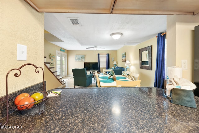 interior space featuring a textured ceiling and ceiling fan