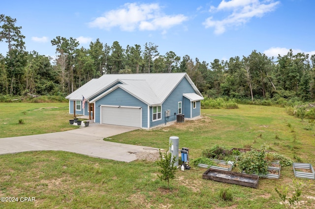 exterior space with cooling unit, a front lawn, and a garage