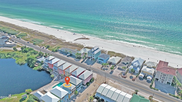 bird's eye view with a water view and a beach view