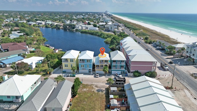 bird's eye view with a water view and a beach view