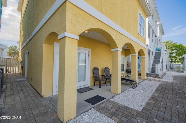 112 Riviera Dr, Panama City Beach, FL 32413 - view of patio / terrace featuring stairs and a gate