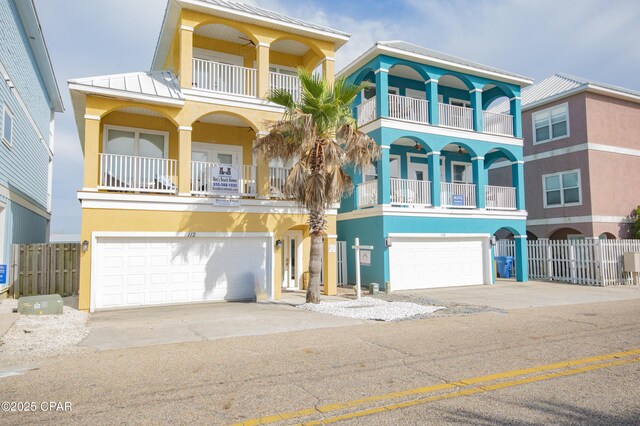 112 Riviera Dr, Panama City Beach, FL 32413 - beach home with a garage, stucco siding, driveway, and a standing seam roof