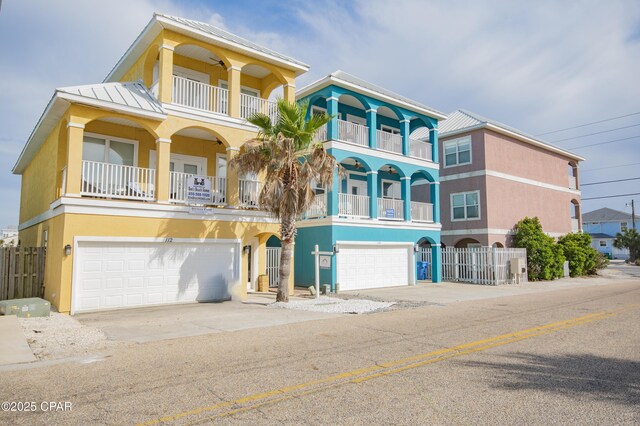 112 Riviera Dr, Panama City Beach, FL 32413 - view of front of property featuring a garage, stucco siding, and a standing seam roof