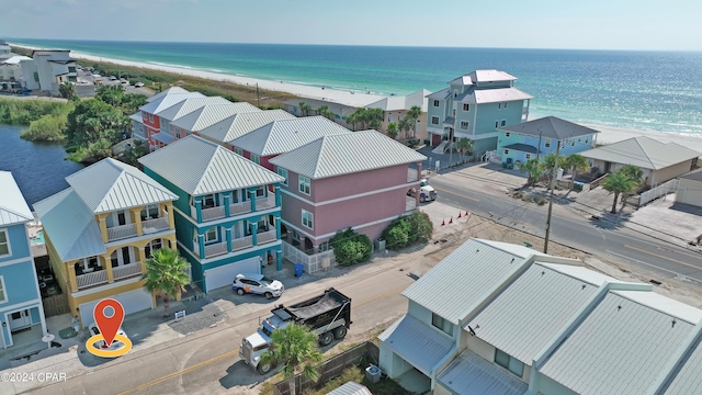 birds eye view of property with a beach view and a water view