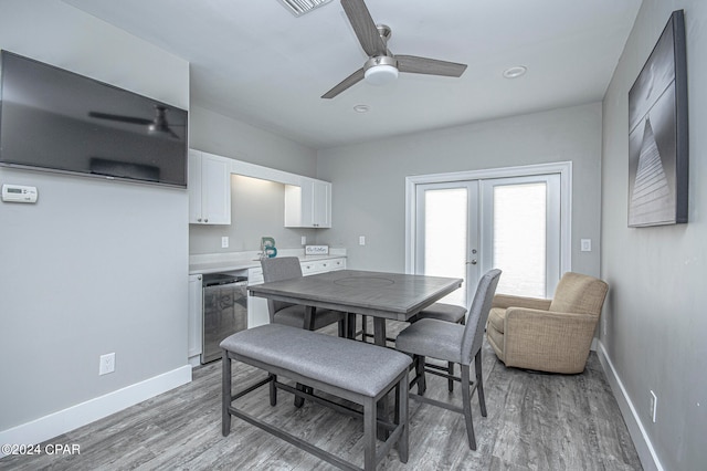 dining room with light wood-type flooring, ceiling fan, and french doors