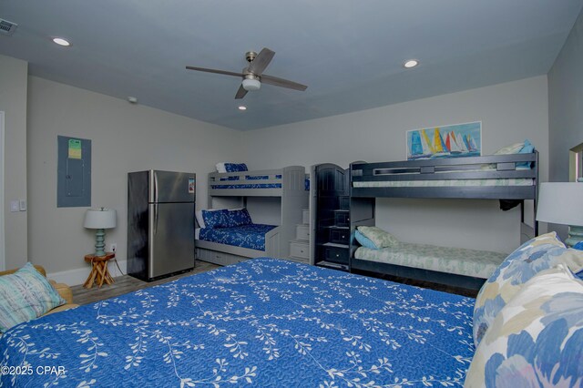 112 Riviera Dr, Panama City Beach, FL 32413 - bedroom featuring freestanding refrigerator, electric panel, baseboards, recessed lighting, and wood finished floors