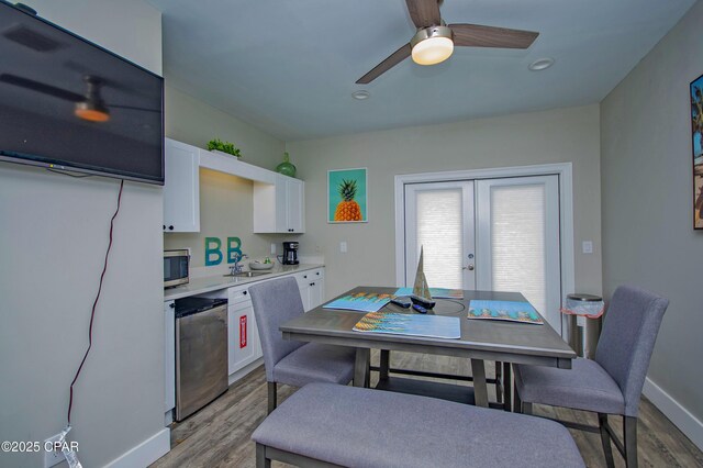 112 Riviera Dr, Panama City Beach, FL 32413 - kitchen featuring stainless steel microwave, wood finished floors, white cabinets, refrigerator, and french doors