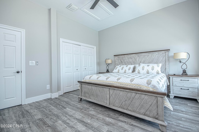 bedroom featuring ceiling fan, a closet, and hardwood / wood-style flooring