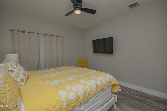112 Riviera Dr, Panama City Beach, FL 32413 - bedroom with wood finished floors, baseboards, and a ceiling fan