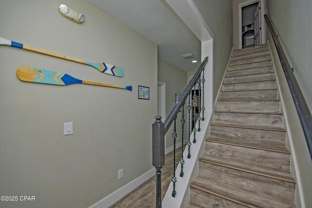 112 Riviera Dr, Panama City Beach, FL 32413 - stairs featuring wood finished floors and baseboards