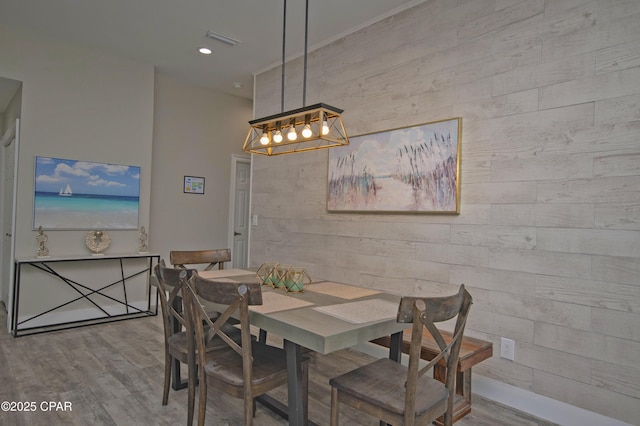 112 Riviera Dr, Panama City Beach, FL 32413 - dining area featuring a chandelier, wood finished floors, wood walls, and recessed lighting