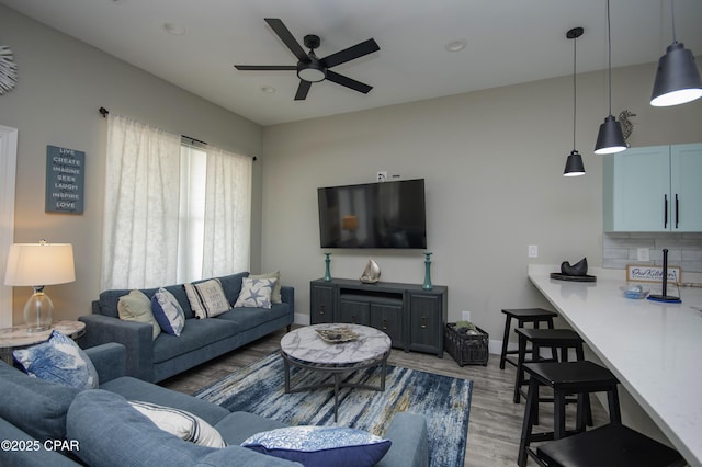 112 Riviera Dr, Panama City Beach, FL 32413 - living room featuring light wood finished floors, ceiling fan, and baseboards