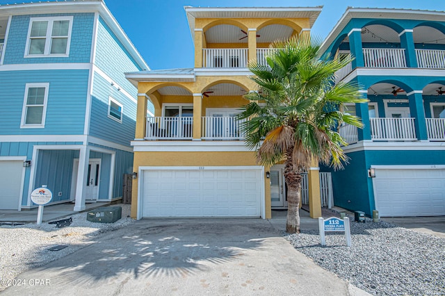 view of property with a balcony and a garage