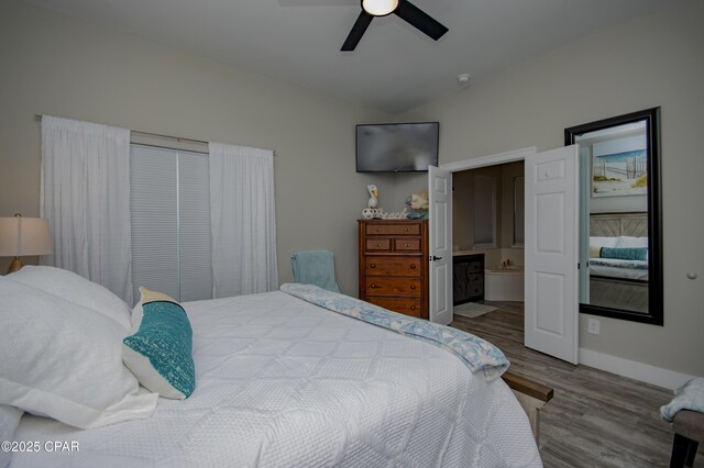 112 Riviera Dr, Panama City Beach, FL 32413 - bedroom featuring wood finished floors, baseboards, lofted ceiling, a ceiling fan, and ensuite bathroom