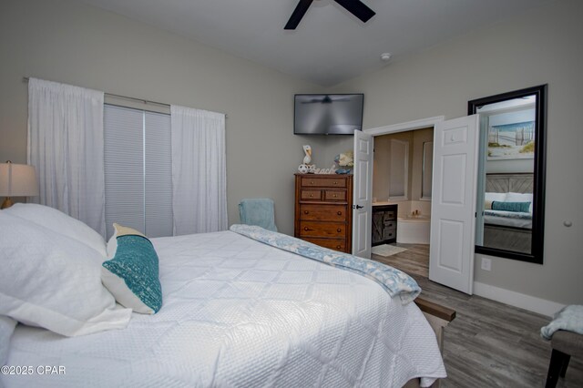 112 Riviera Dr, Panama City Beach, FL 32413 - bedroom featuring wood finished floors, baseboards, ensuite bath, and a ceiling fan