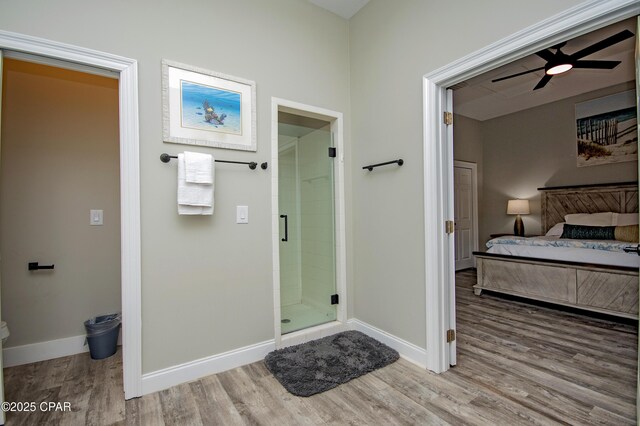 112 Riviera Dr, Panama City Beach, FL 32413 - full bathroom featuring wood finished floors, a shower stall, a ceiling fan, and baseboards