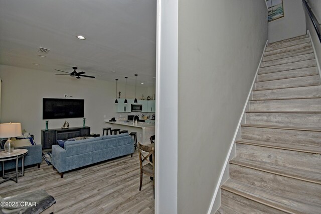 112 Riviera Dr, Panama City Beach, FL 32413 - staircase with wood finished floors, ceiling fan, and recessed lighting