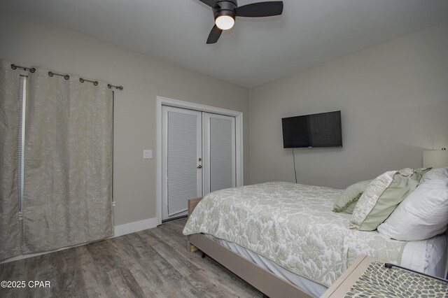 112 Riviera Dr, Panama City Beach, FL 32413 - bedroom featuring wood finished floors, a closet, baseboards, and a ceiling fan