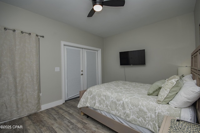 112 Riviera Dr, Panama City Beach, FL 32413 - bedroom with wood finished floors, a closet, baseboards, and a ceiling fan