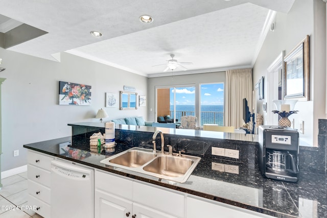 kitchen with ceiling fan, light tile patterned floors, sink, white cabinetry, and dishwasher