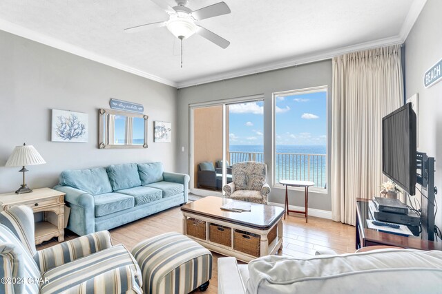 living room featuring light hardwood / wood-style floors, ceiling fan, and crown molding