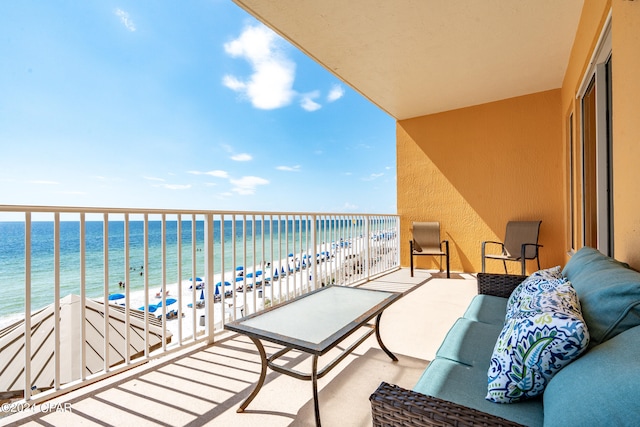 balcony with a beach view and a water view