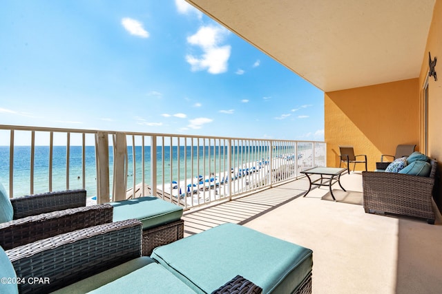 balcony with a beach view and a water view