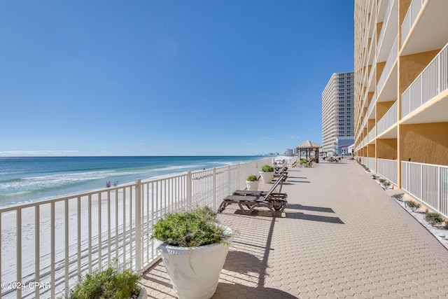 exterior space featuring a water view and a beach view