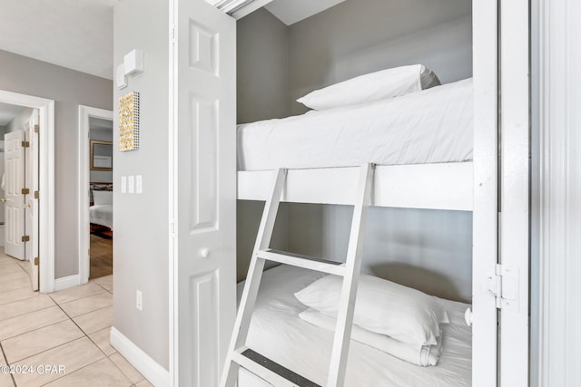 bedroom featuring tile patterned floors and baseboards