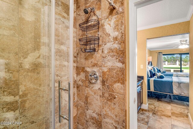 bathroom featuring a shower with door, a textured ceiling, vanity, ceiling fan, and ornamental molding