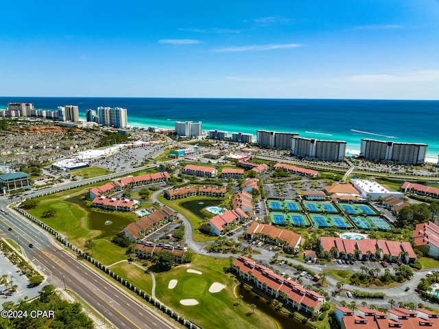 drone / aerial view with a view of city, view of golf course, and a water view