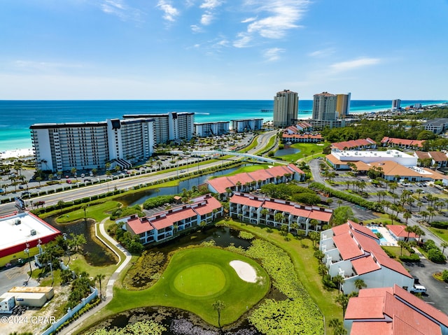 birds eye view of property with view of golf course and a water view