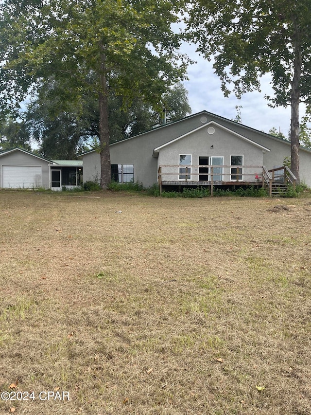 exterior space with a wooden deck and a front yard