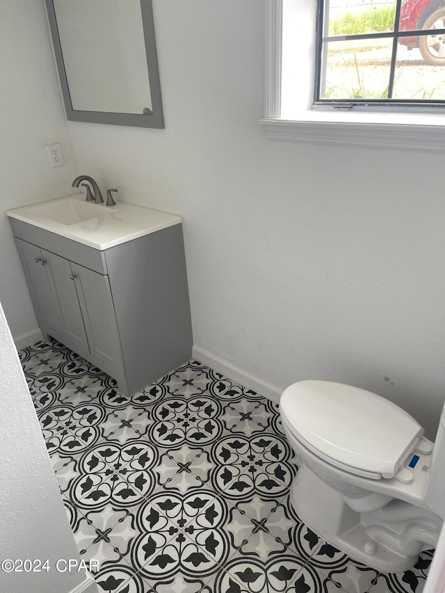 bathroom featuring tile patterned floors, vanity, and toilet