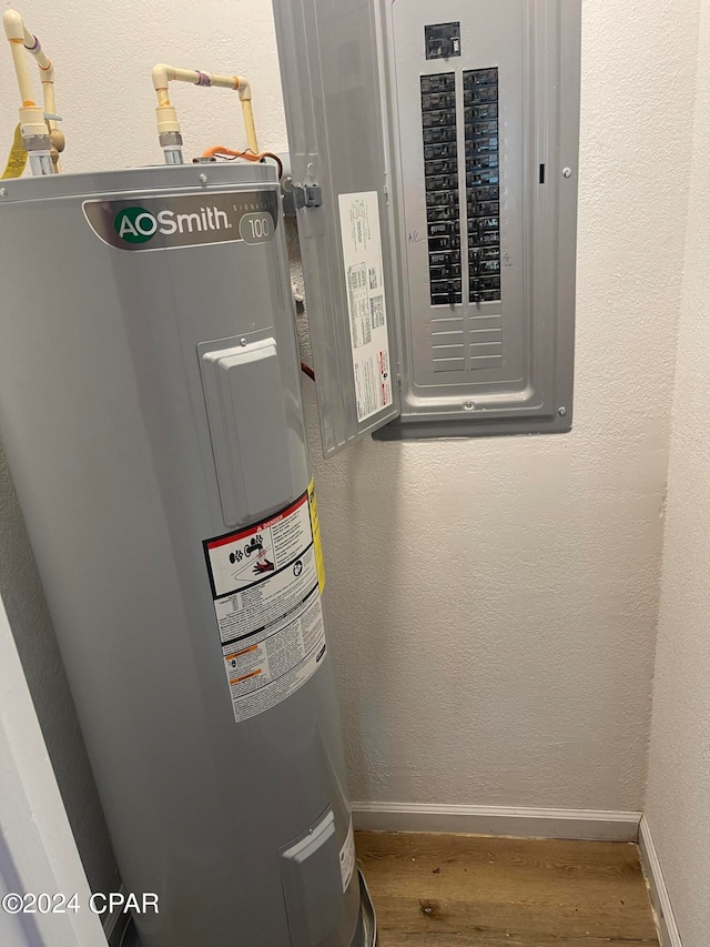 utility room featuring electric water heater and electric panel